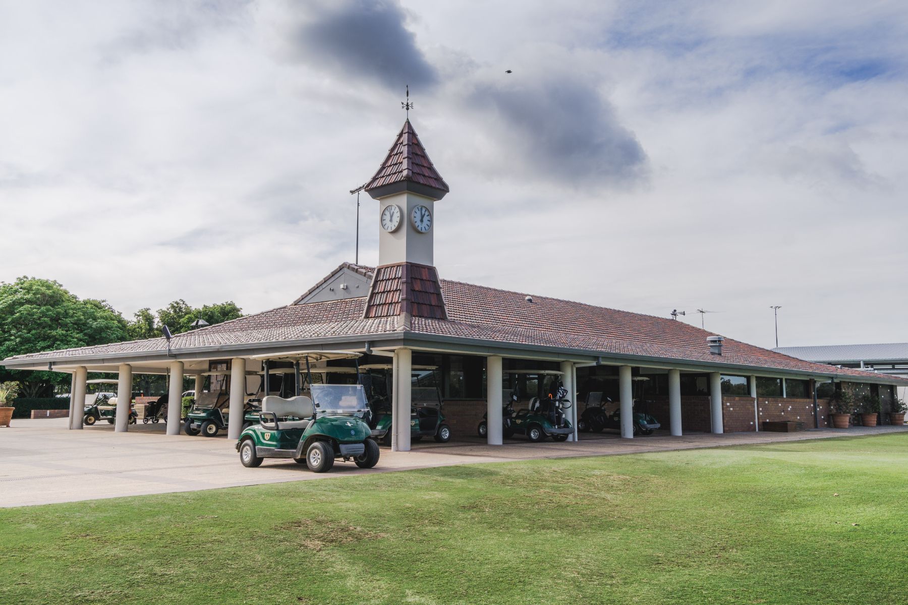 a golf cart parked in front of a building with a clock tower